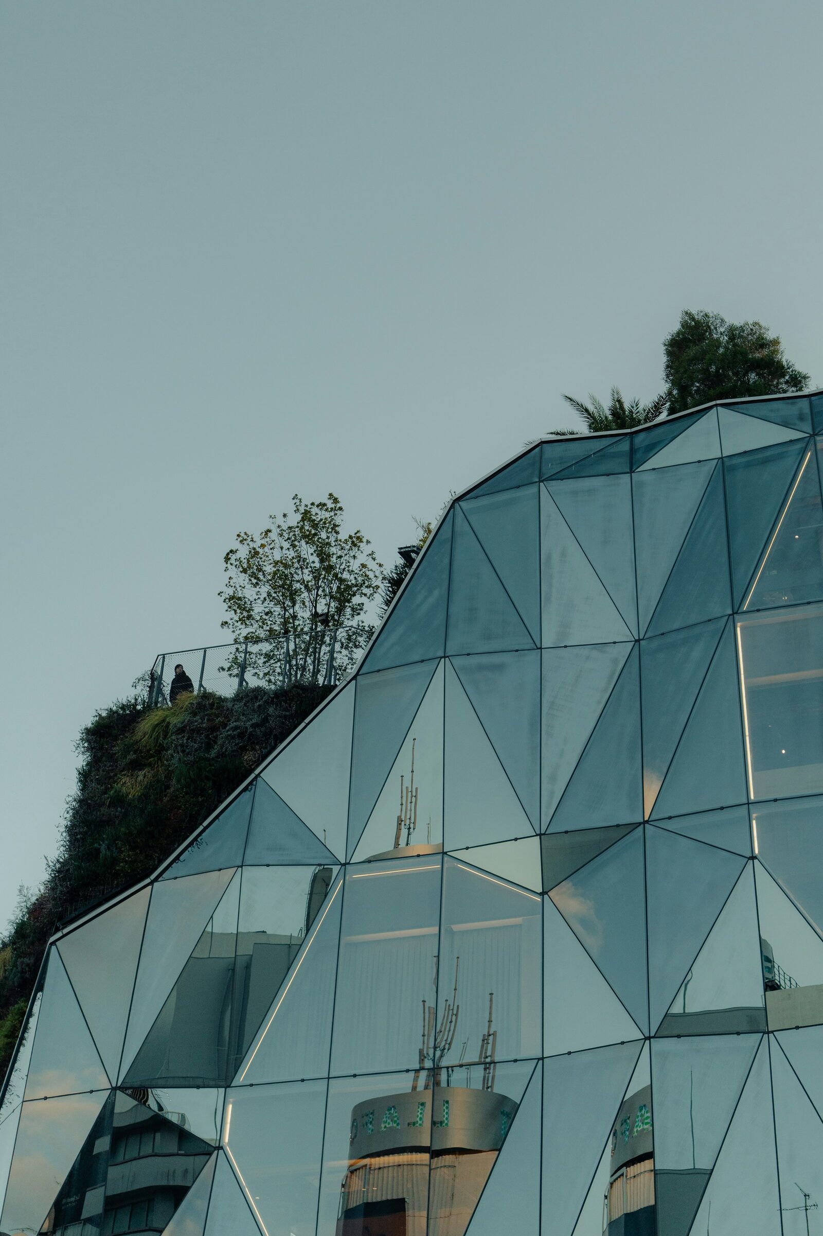 Geometric glass architecture with integrated greenery in Tokyo